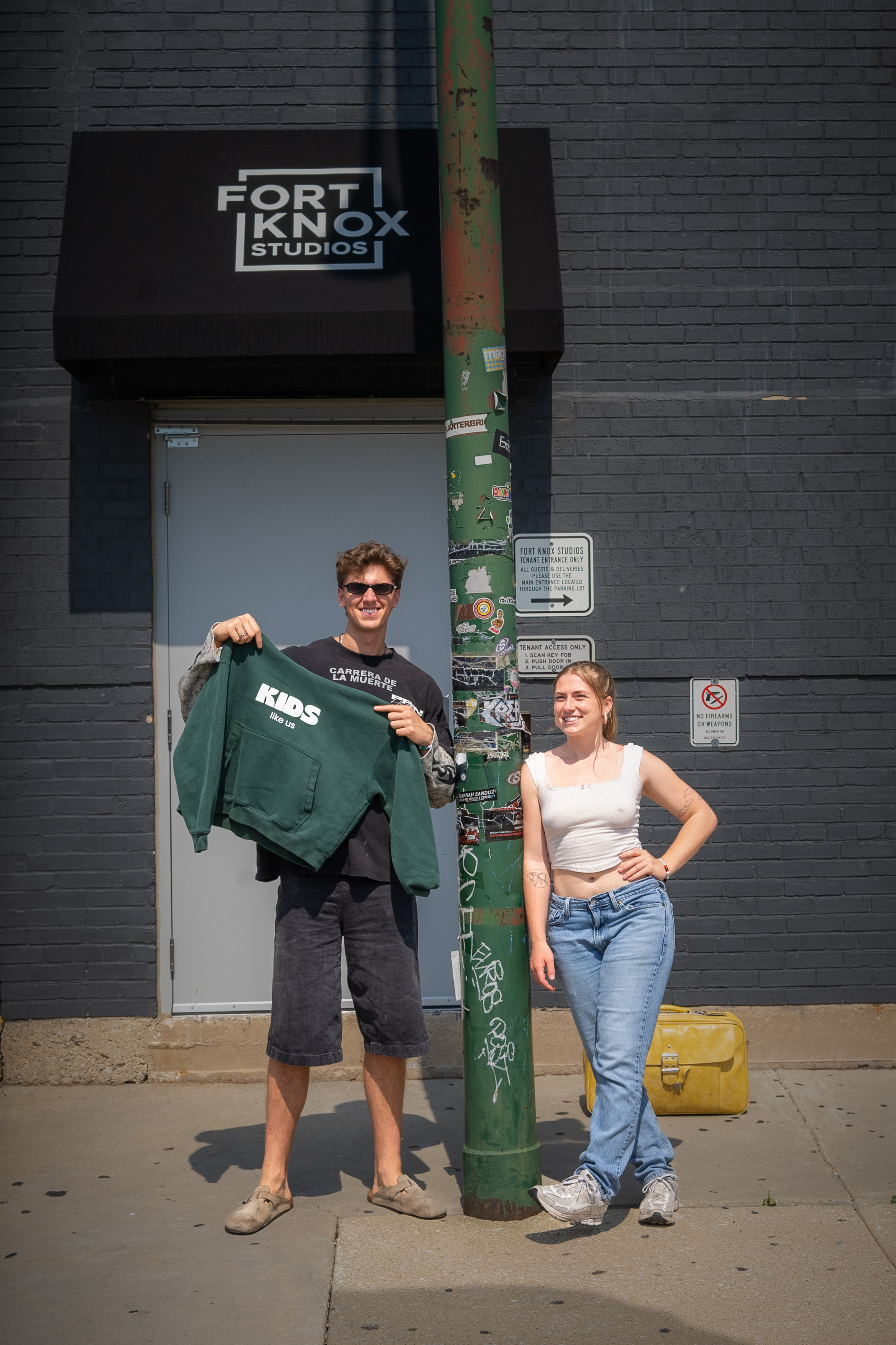 Eddie holds the KIDS crewneck outside Fort Knox Studios